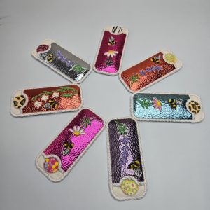 Embroidered Nail File Sleeve includes emery board